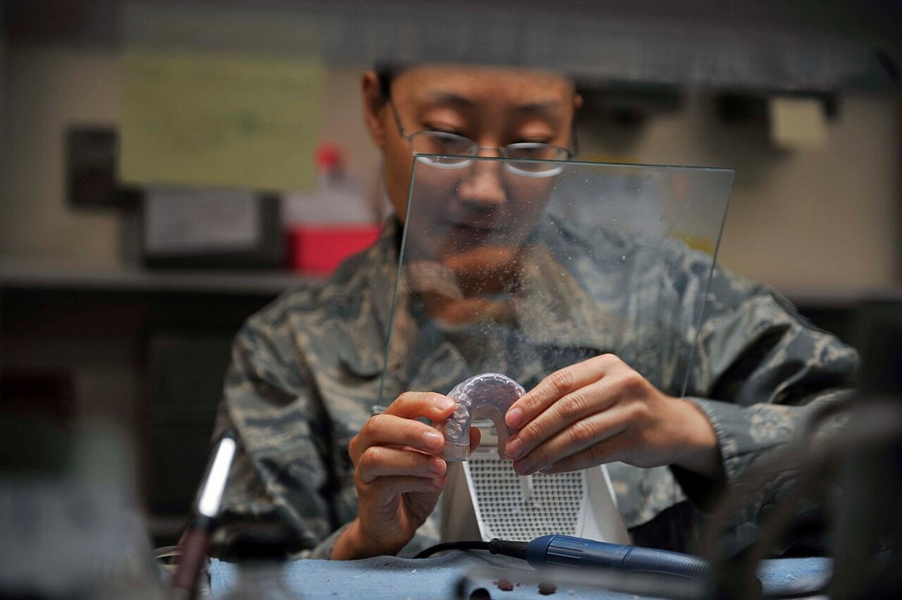 Dental technician finishing a clear aligner in the lab